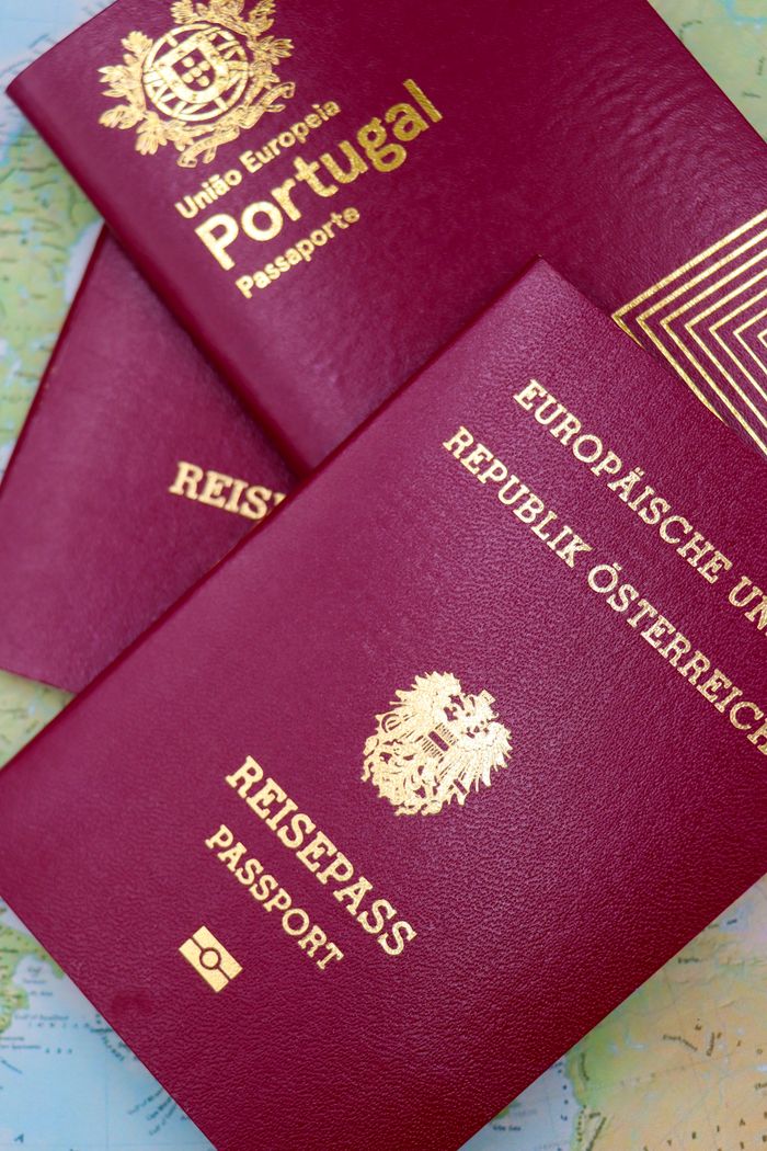 Close-up of Portugal and Austrian passports on a map, symbolizing travel and European mobility.