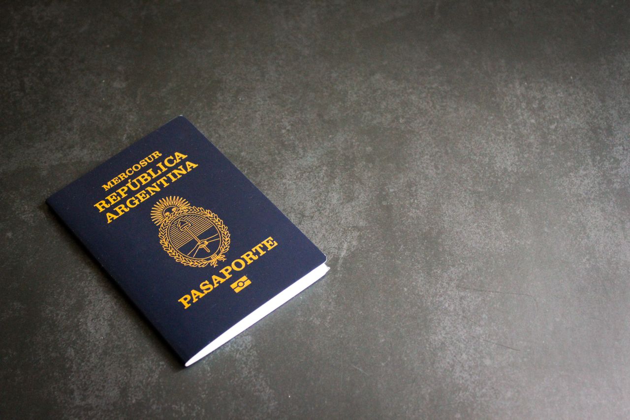 High-quality image of an Argentinian passport on a dark slate background, ideal for travel themes.